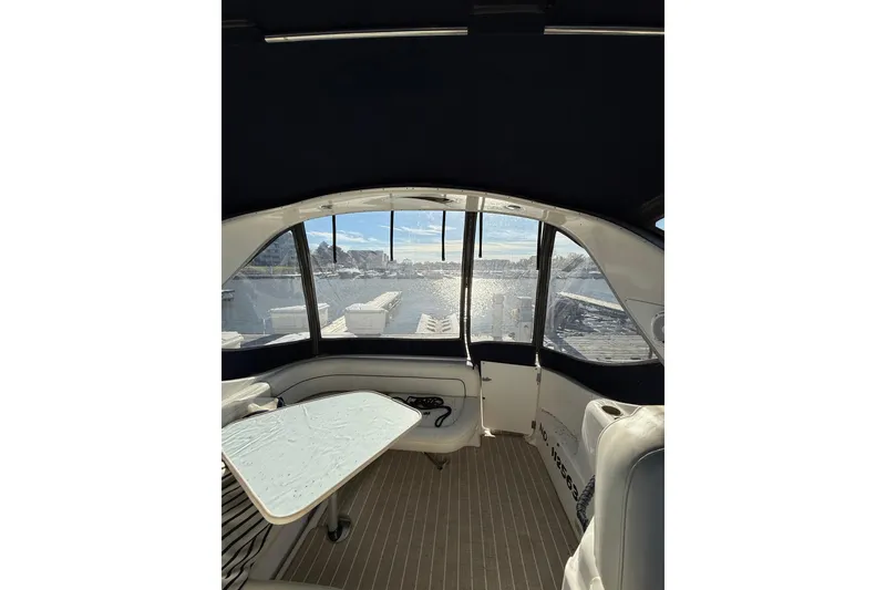 Slide: The Image of Interior view of 2000 Bayliner 3055 Ciera Sunbridge DX/LX with waterfront scenery. - 4
