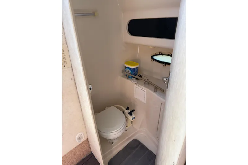 Slide: The Image of Interior of 2000 Bayliner 3055 Ciera Sunbridge DX/LX boat bathroom with toilet and window. - 7