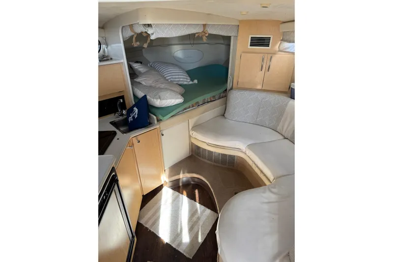 Slide: The Image of Interior of 2000 Bayliner 3055 Ciera Sunbridge DX/LX with cozy seating and sleeping area. - 9