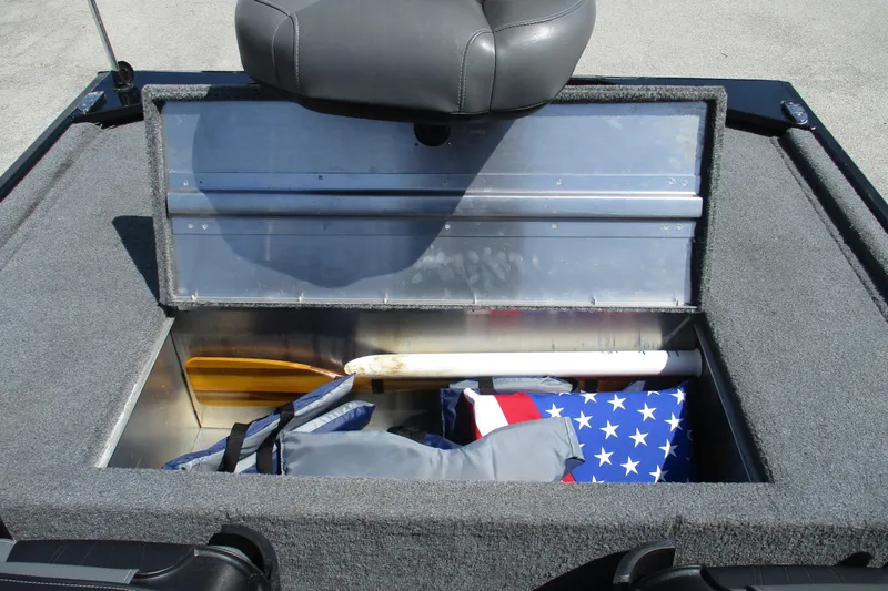 Slide: The Image of 2022 Tracker Bass Tracker Classic XL boat storage compartment with gear and American flag. - 17