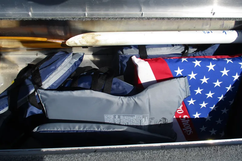 Slide: The Image of Storage compartment of 2022 Tracker Bass Tracker Classic XL with life jackets and paddles. - 18