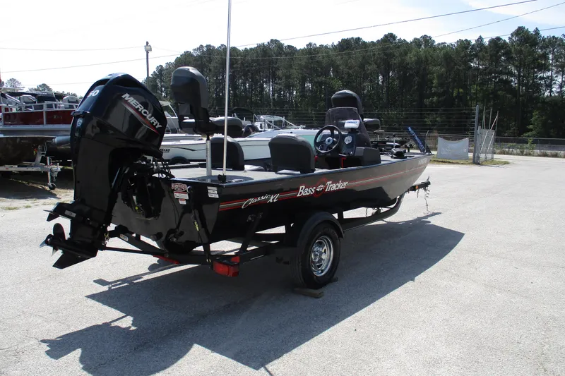 Slide: The Image of 2022 Tracker Bass Tracker Classic XL boat with Mercury engine in outdoor setting. - 6
