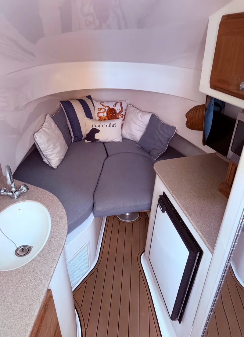 Slide: The Image of 2007 Contender 36 Fish Around cabin interior with cozy seating and compact kitchenette. - 6