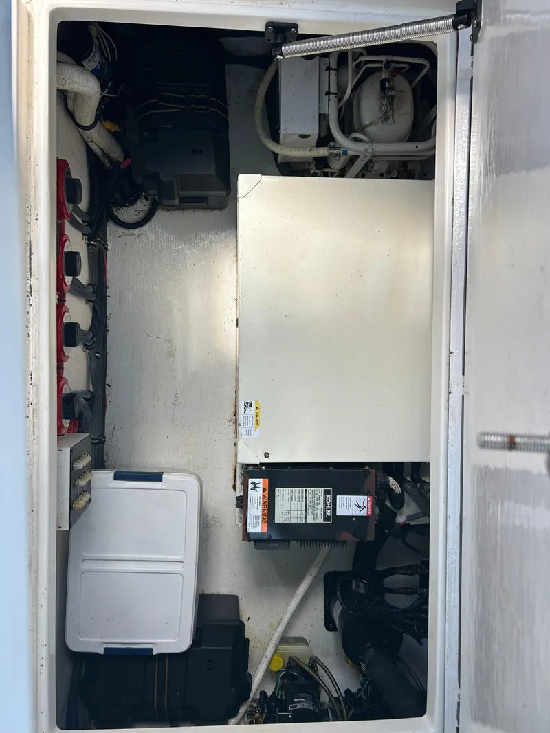 Slide: The Image of 2007 Contender 36 Fish Around engine compartment with equipment and storage. - 7