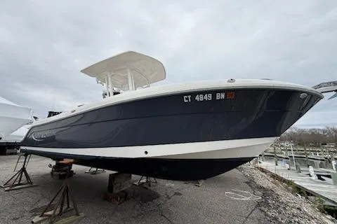 The Image of 2021 Robalo R242 Explorer boat on stands, dockside view. - 0