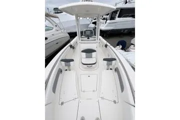 Slide: The Image of 2021 Robalo R242 Explorer boat interior with seating and storage compartments. - 3