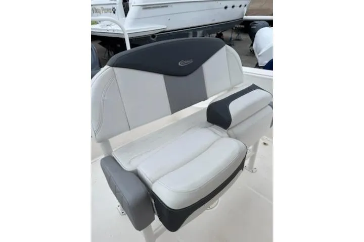 Slide: The Image of 2021 Robalo R242 Explorer boat seat with gray and white cushioned design. - 7