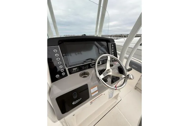 Slide: The Image of 2021 Robalo R242 Explorer boat dashboard with steering wheel and control panel. - 9