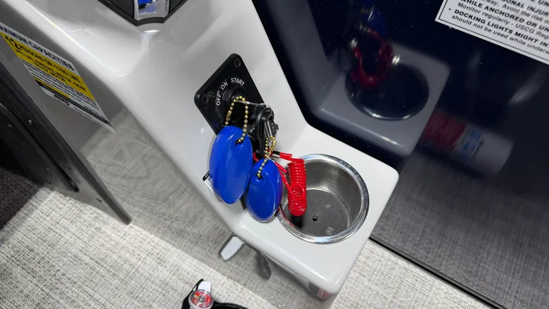 Slide: The Image of Ignition keys and cup holder on a boat. - 39