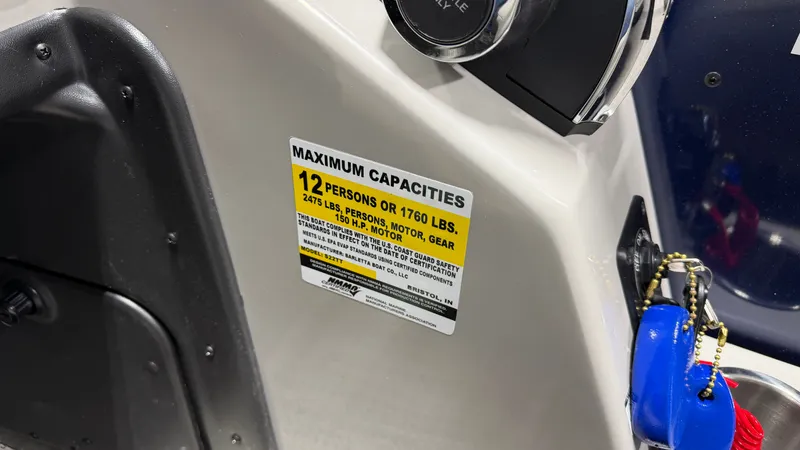 Slide: The Image of Close-up of a capacity label on a boat, accommodating 12 people. - 41