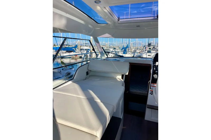 Slide: The Image of Interior view of 2020 Beneteau Antares 9 OB boat with marina background. - 10