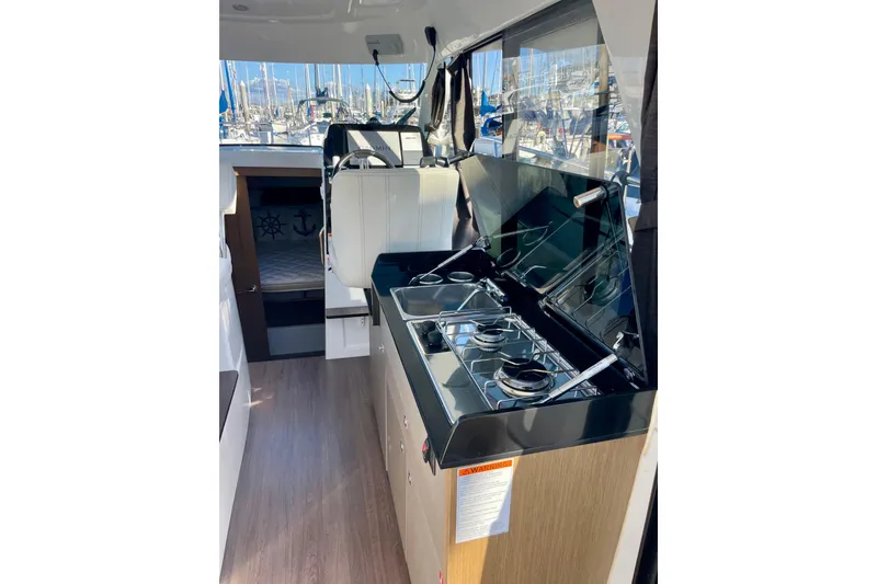 Slide: The Image of Interior of 2020 Beneteau Antares 9 OB with modern kitchen and cozy cabin. - 11