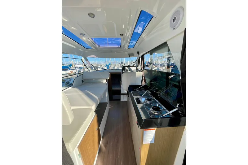Slide: The Image of Interior of 2020 Beneteau Antares 9 OB boat with seating and kitchen area. - 13