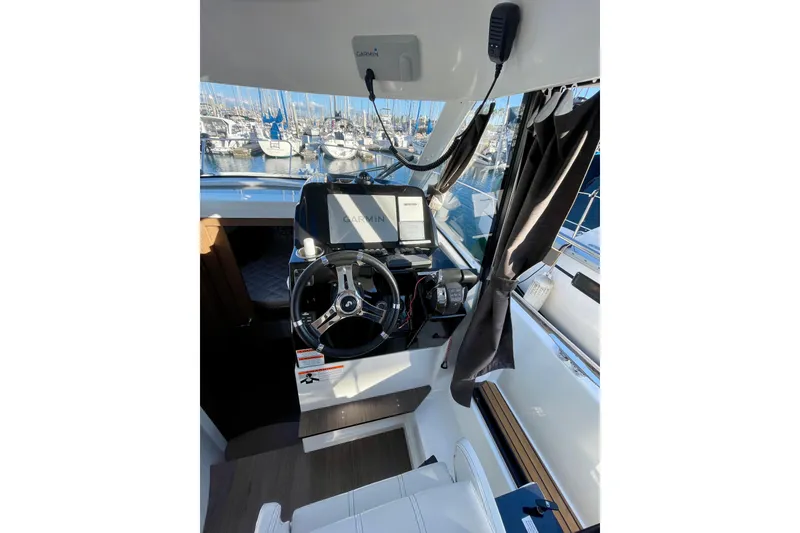 Slide: The Image of Interior view of 2020 Beneteau Antares 9 OB boat cockpit with Garmin navigation system. - 17