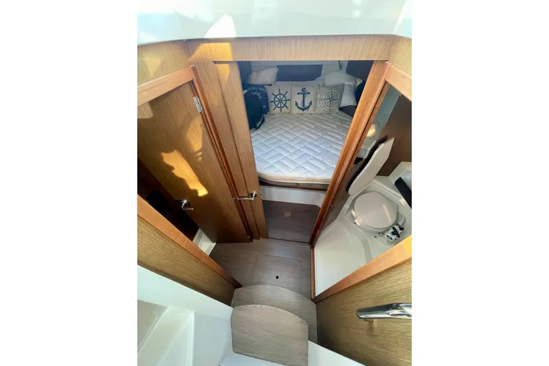 Slide: The Image of Interior of 2020 Beneteau Antares 9 OB, featuring cozy cabin and compact bathroom. - 22
