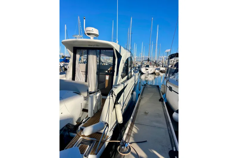 Slide: The Image of 2020 Beneteau Antares 9 OB docked at marina, showcasing sleek design and modern features. - 23