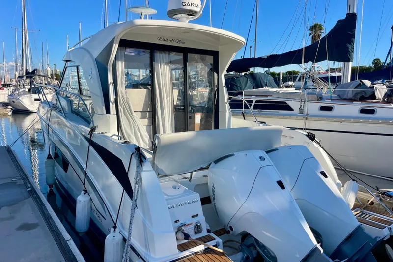 Slide: The Image of 2020 Beneteau Antares 9 OB docked, featuring dual outboard engines and sleek design. - 29