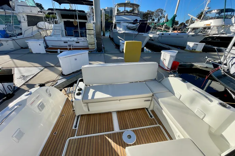 Slide: The Image of 2020 Beneteau Antares 9 OB boat interior with seating, docked at marina. - 7