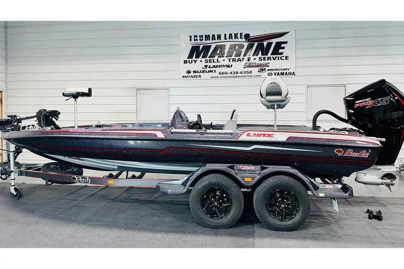 The Image of 2026 Bass Cat Lynx STS boat on trailer at Truman Lake Marine showroom. - 1