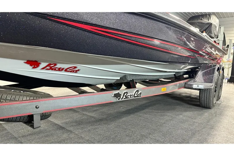 Slide: The Image of 2026 Bass Cat Lynx STS boat on trailer, showcasing sleek design and branding. - 13
