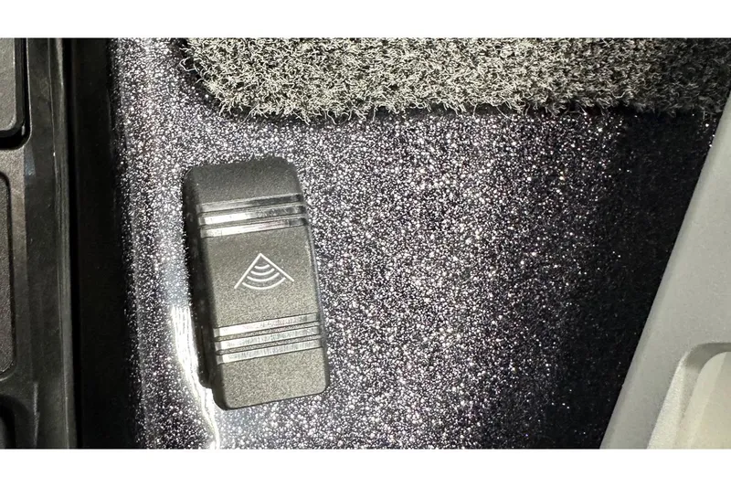 Slide: The Image of Close-up of 2026 Bass Cat Lynx STS boat control panel with textured surface. - 19