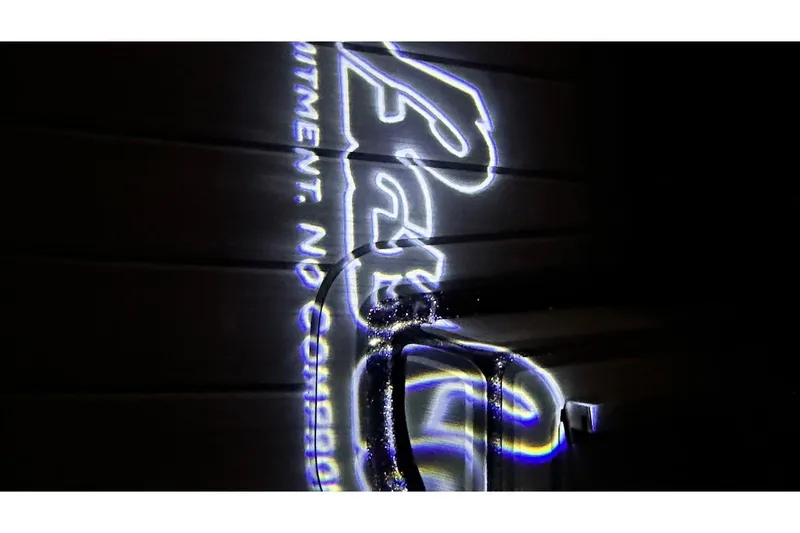 Slide: The Image of Illuminated Bass Cat Lynx STS logo projection, showcasing sleek design and branding. - 26