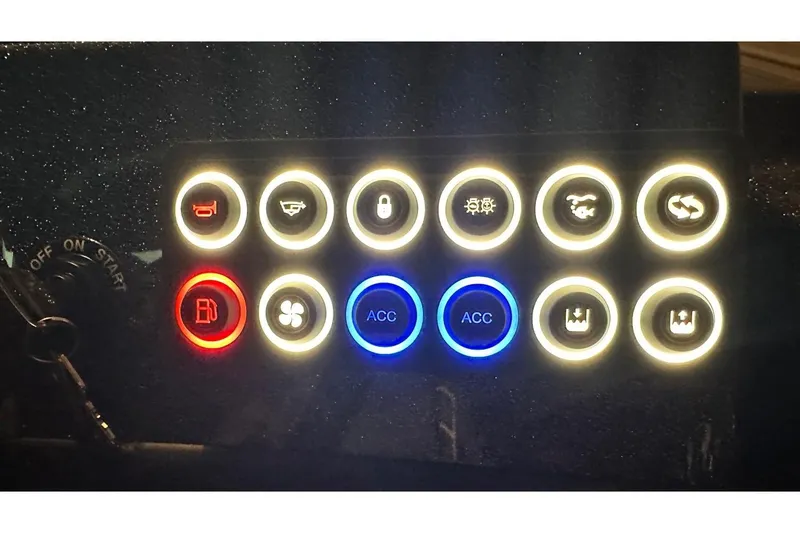 Slide: The Image of Dashboard controls of 2026 Bass Cat Lynx STS boat, featuring illuminated buttons and switches. - 27