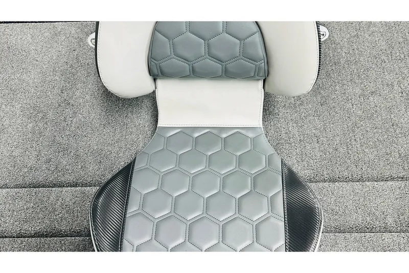 Slide: The Image of 2026 Bass Cat Lynx STS seat with hexagonal pattern and carbon fiber accents. - 28