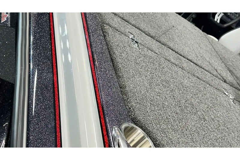 Slide: The Image of 2026 Bass Cat Lynx STS boat deck with textured gray surface and sleek metallic accents. - 7