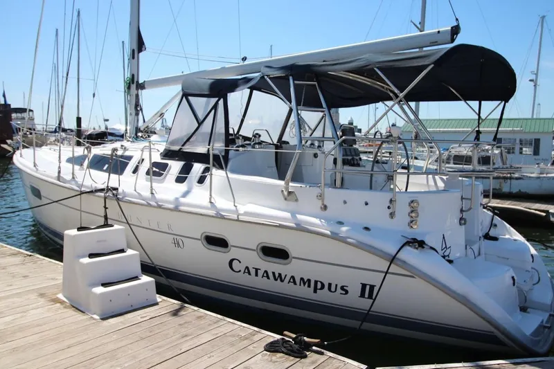 The Image of Sailboat "Catawampus II" docked, Hunter 410 model, year 2000, with canopy and marina background. - 0