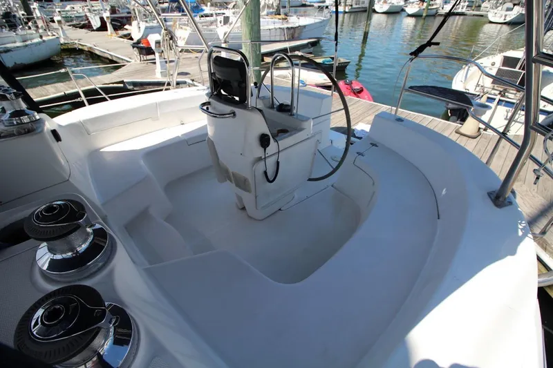 Slide: The Image of Cockpit of a 2000 Hunter 410 sailboat docked at a marina. - 12