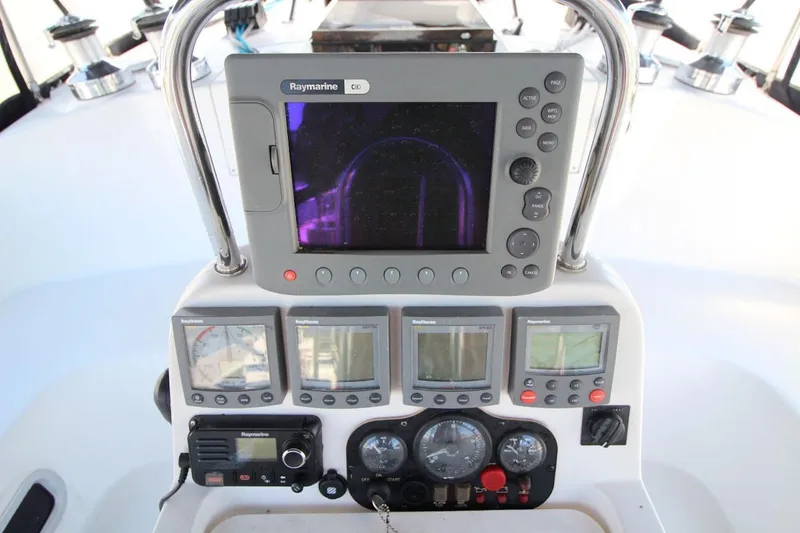Slide: The Image of Cockpit navigation instruments on a 2000 Hunter 410 sailboat, featuring Raymarine displays. - 15