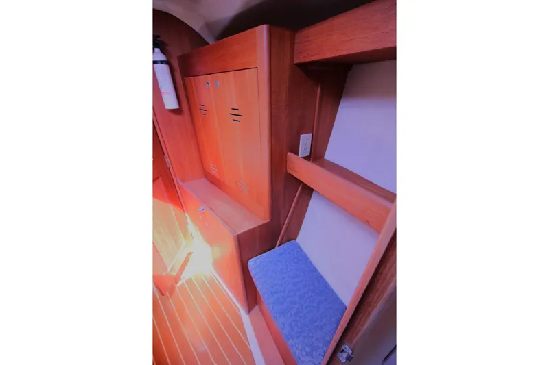 Slide: The Image of Interior of 2000 Hunter 410 sailboat with wooden cabinetry and seating. - 22