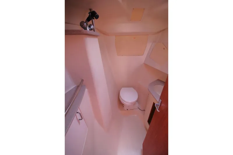 Slide: The Image of Compact bathroom interior of a 2000 Hunter 410 boat, featuring a toilet and sink. - 23