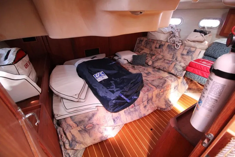 Slide: The Image of Cozy cabin interior of a 2000 Hunter 410 sailboat with bedding and safety equipment. - 24