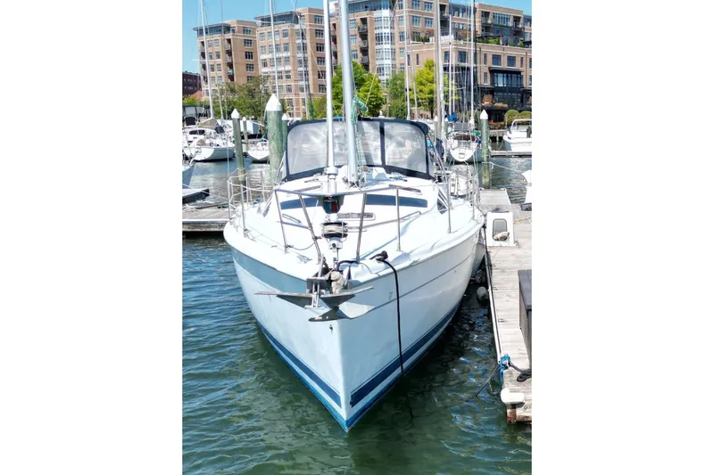 Slide: The Image of Sailboat docked in marina, Hunter 410 model, year 2000, with urban backdrop. - 5