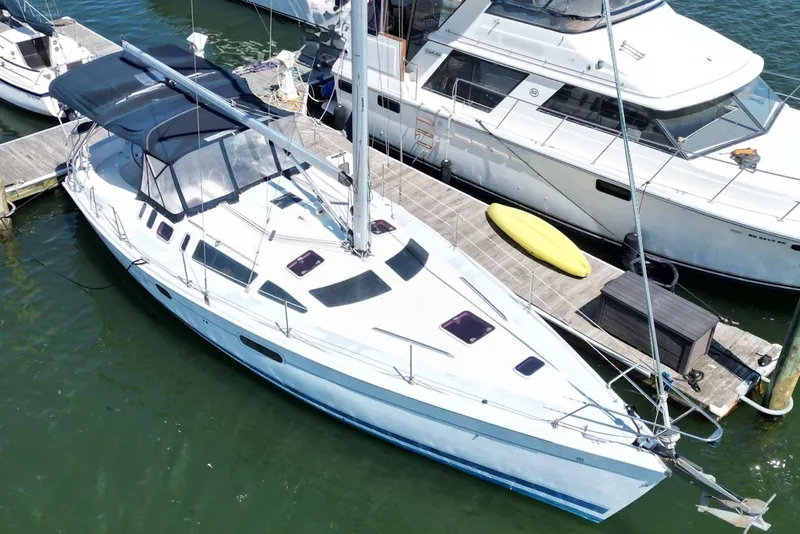 Slide: The Image of Sailboat Hunter 410, year 2000, docked at marina with adjacent vessels. - 8