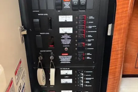 Slide: The Image of Control panel of a 2003 Sea Ray 340 Sundancer boat, showing switches and gauges. - 24