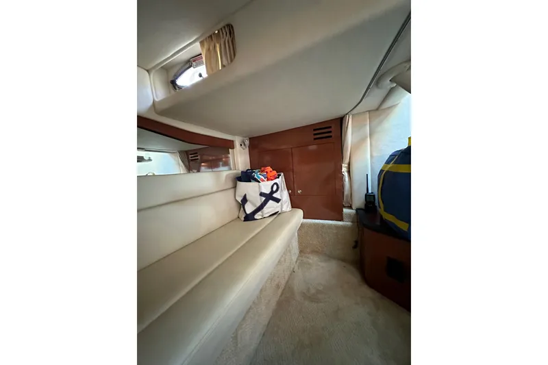 Slide: The Image of Interior of 2003 Sea Ray 340 Sundancer yacht with seating and storage area. - 32