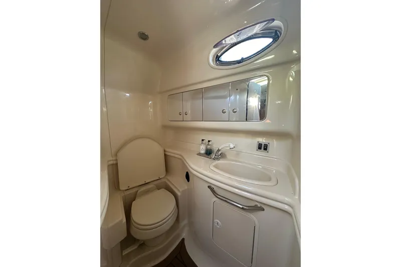Slide: The Image of Bathroom interior of 2003 Sea Ray 340 Sundancer yacht, featuring sink and toilet. - 33
