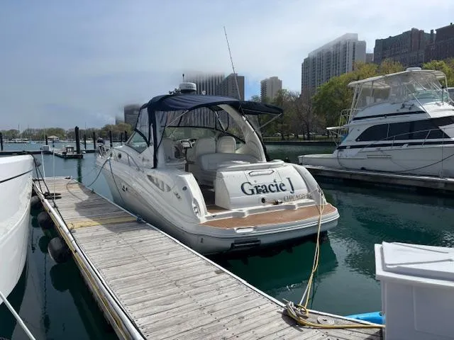 Slide: The Image of 2003 Sea Ray 340 Sundancer docked, rear view, named "Gracie J" in Chicago marina. - 8