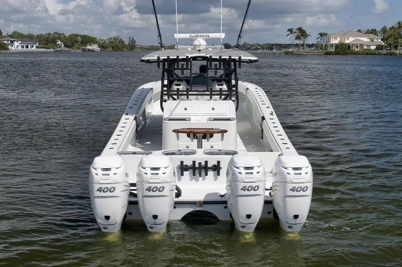 Slide: The Image of Freeman 42LR 2020 boat with four powerful outboard engines on a calm waterway. - 10