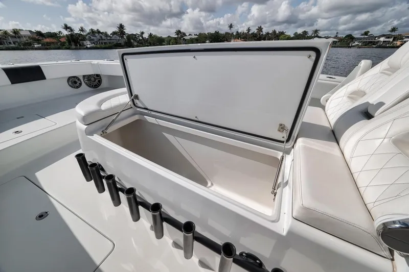 Slide: The Image of Open storage compartment on 2020 Freeman 42LR boat with rod holders and seating. - 17