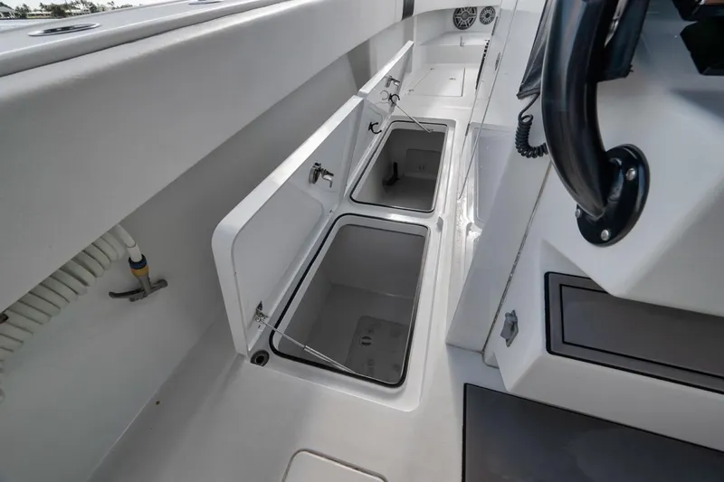 Slide: The Image of Open storage compartments on a 2020 Freeman 42LR boat deck. - 19