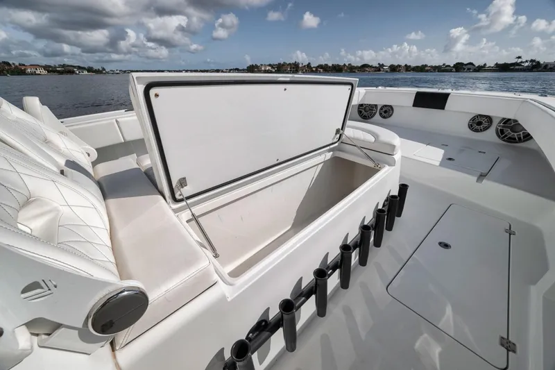 Slide: The Image of 2020 Freeman 42LR boat with open storage compartment and rod holders on deck. - 23