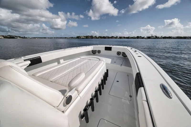Slide: The Image of 2020 Freeman 42LR boat with spacious deck and seating, cruising on calm waters under a cloudy sky. - 24