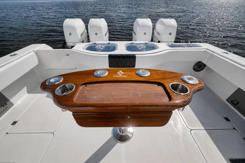Slide: The Image of Luxury Freeman 42LR boat deck with wooden table and four powerful outboard engines, 2020 model. - 34