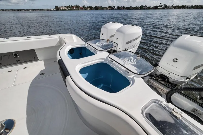 Slide: The Image of Freeman 42LR 2020 boat with dual Mercury engines and livewell on calm water. - 37
