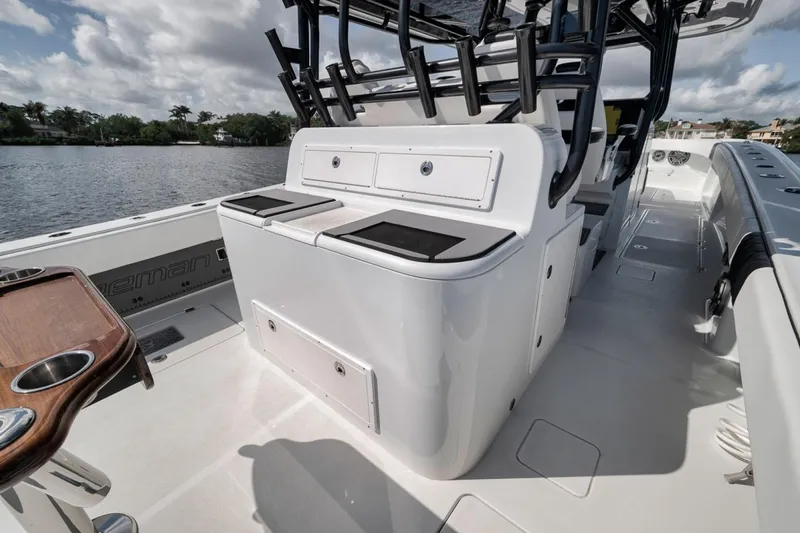 Slide: The Image of 2020 Freeman 42LR boat interior with seating and storage, docked on a sunny day. - 40
