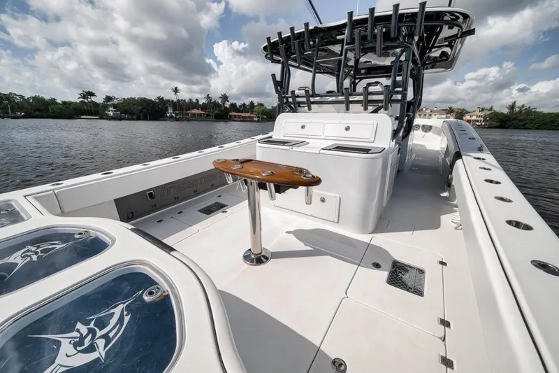 Slide: The Image of 2020 Freeman 42LR boat with spacious deck and fishing rod holders on a sunny day. - 41